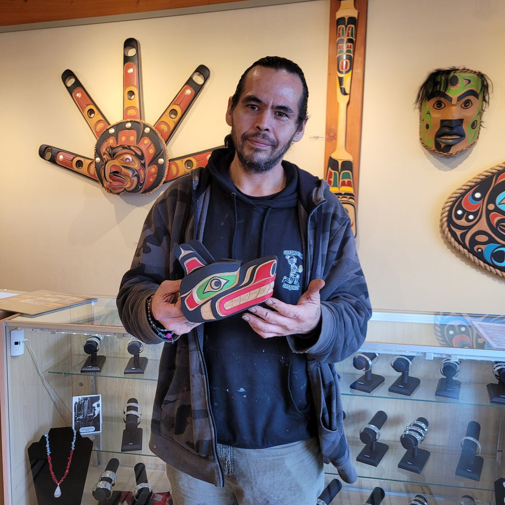 Gilbert Dawson holding his small wolf mask carved from cedar