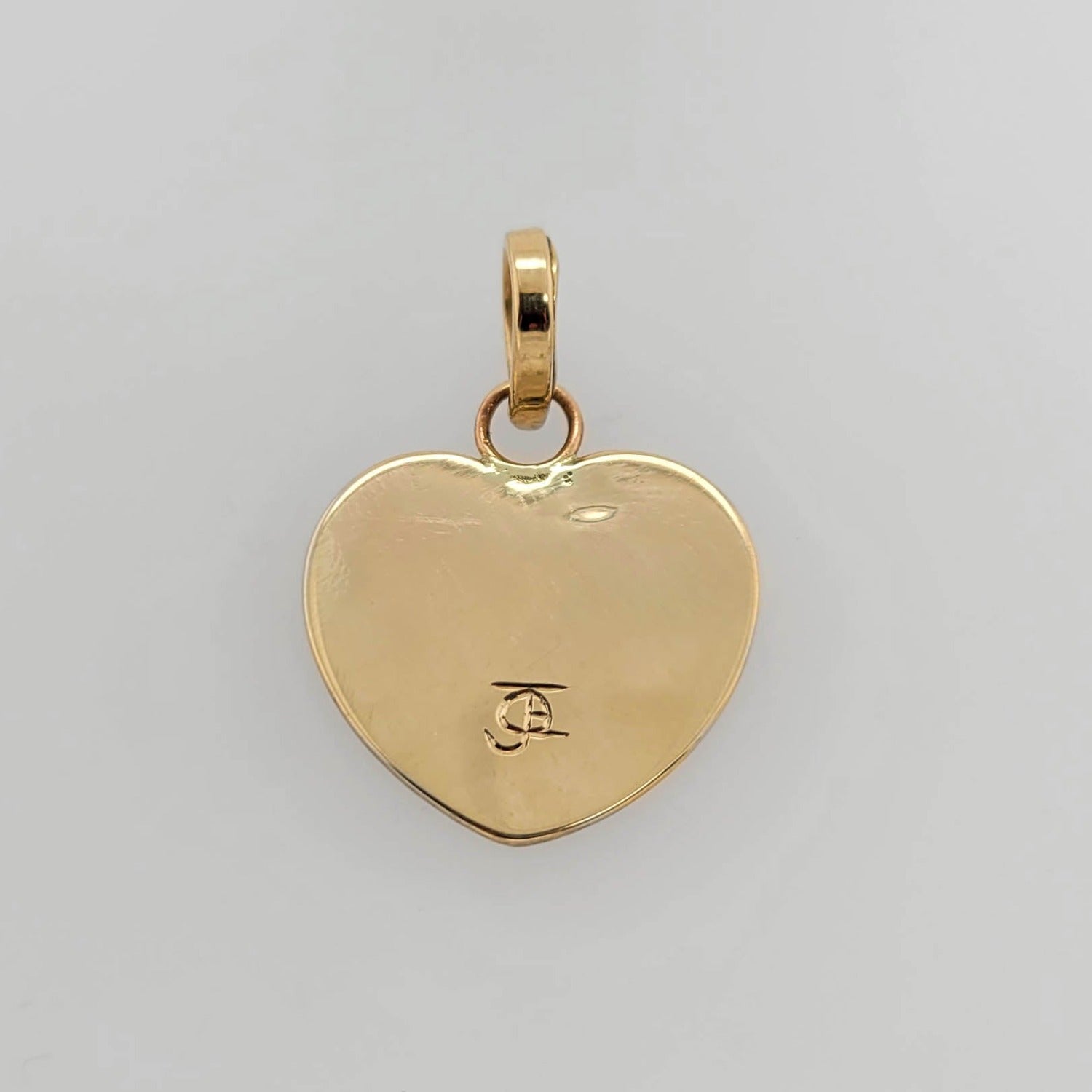 Gold Raven Heard Pendant by Kwakwaka'wakw artist Joe Wilson