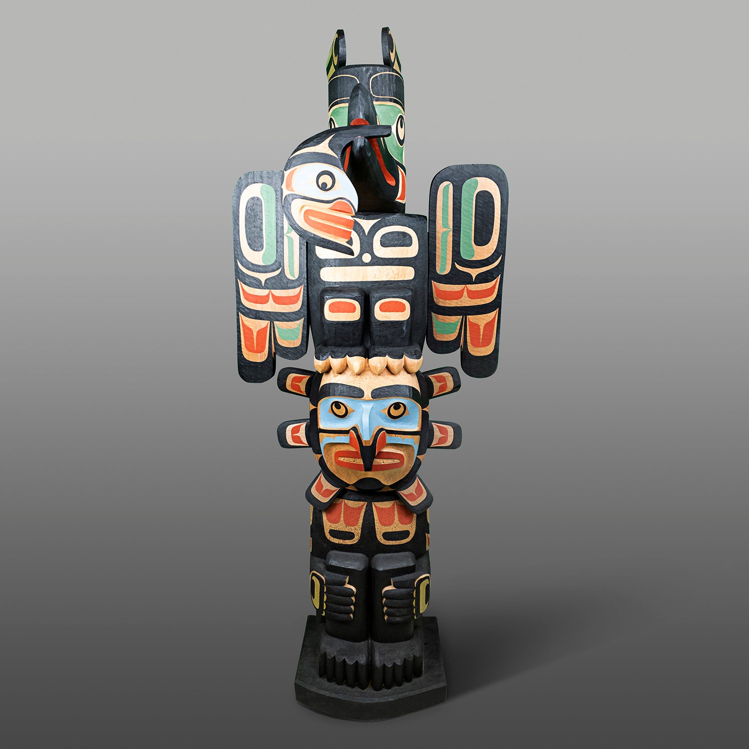 Raven and Sun Totem Pole by Kwagul Master Carver Calvin Hunt