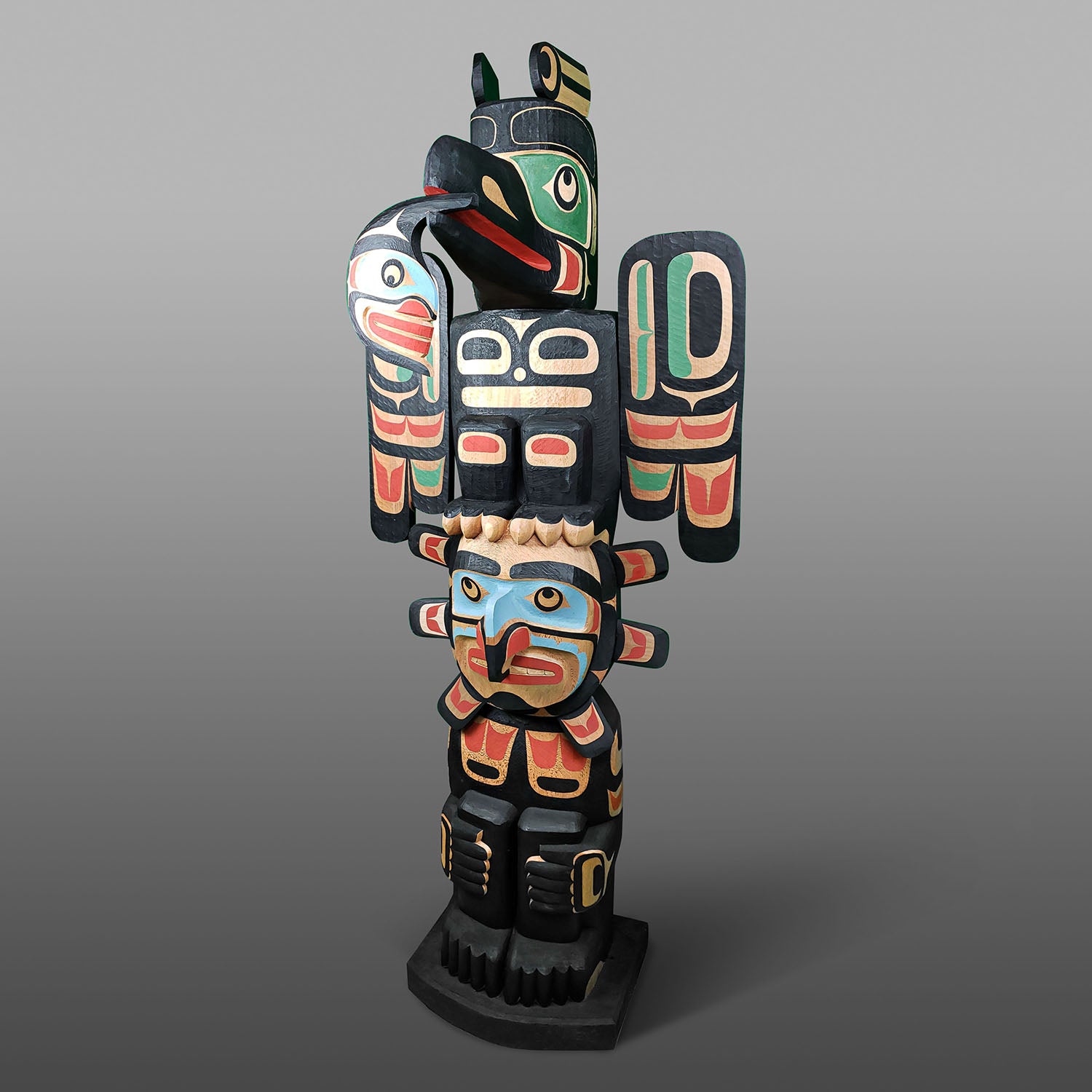 Raven and Sun Totem Pole by Kwagul Master Carver Calvin Hunt