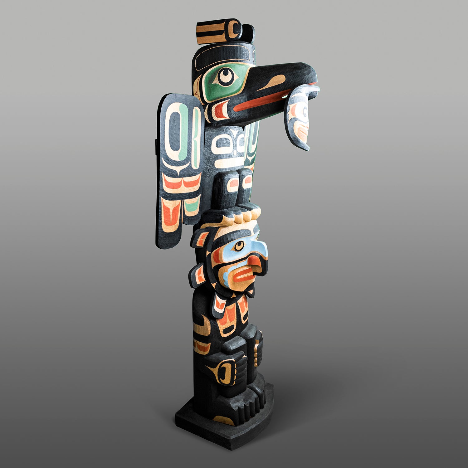 Raven and Sun Totem Pole by Kwagul Master Carver Calvin Hunt