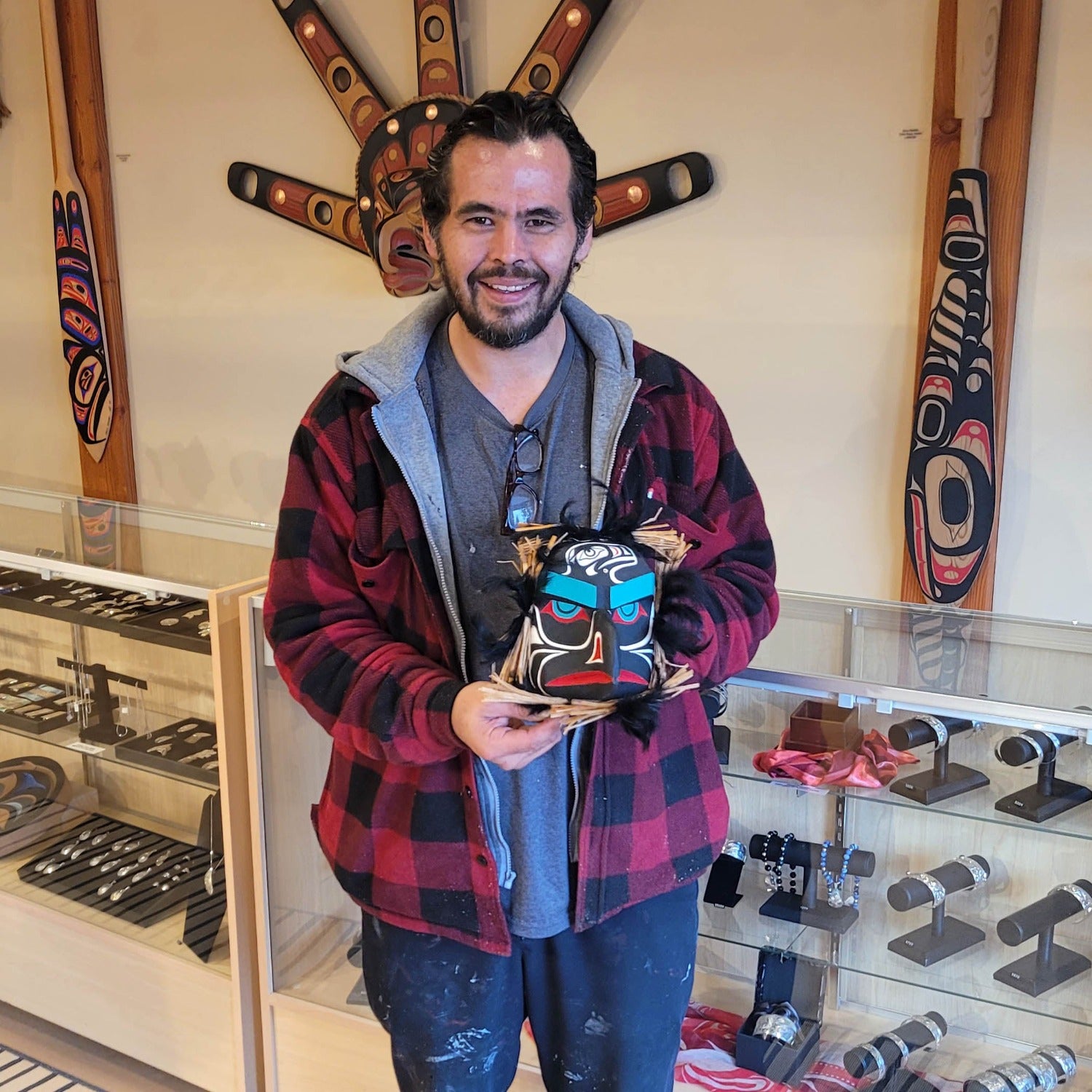 Kwakwaka'wakw carver Gilbert Dawson holding small Raven Mask