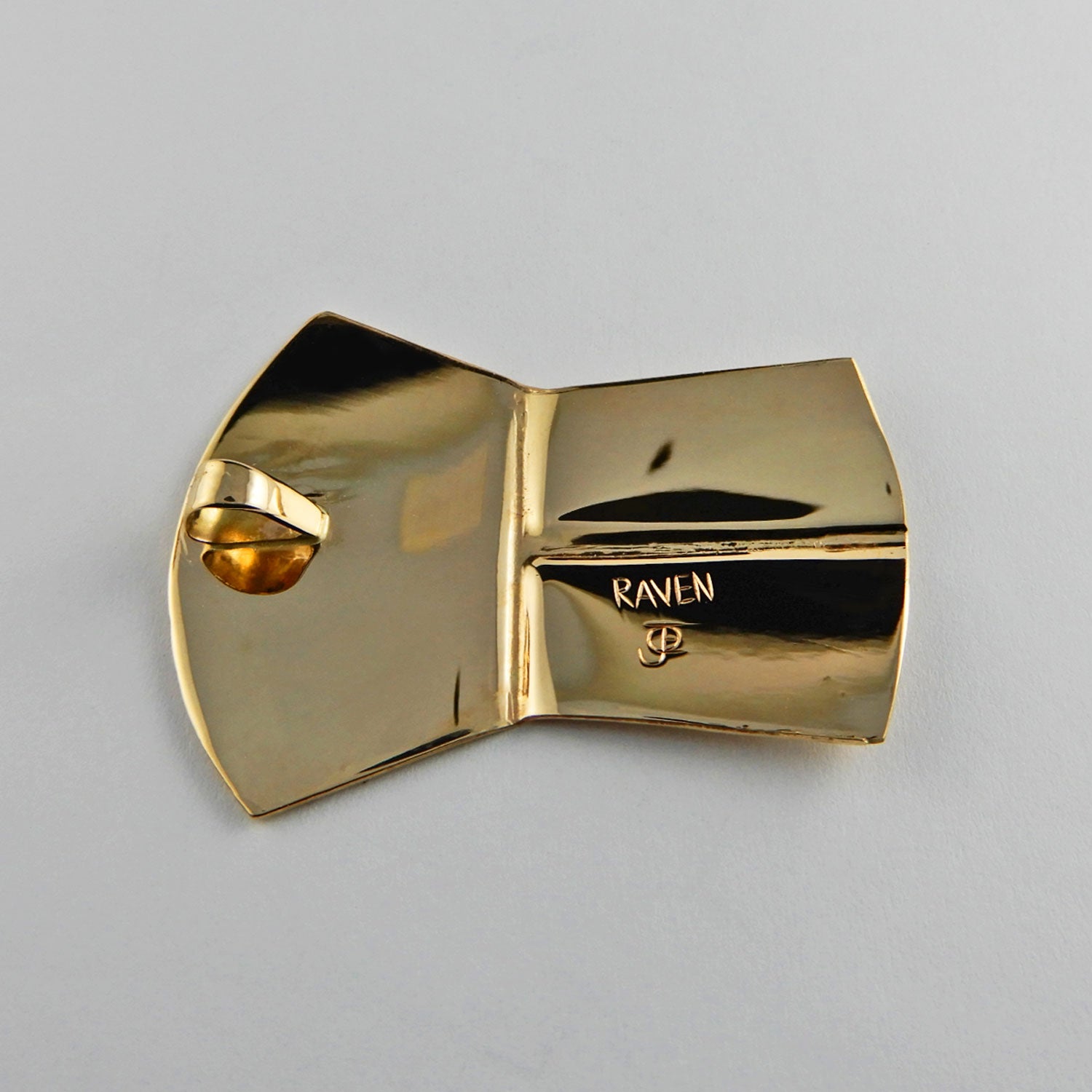 Gold copper-shaped Raven Pendant by Kwakwaka'wakw artist Joe Wilson