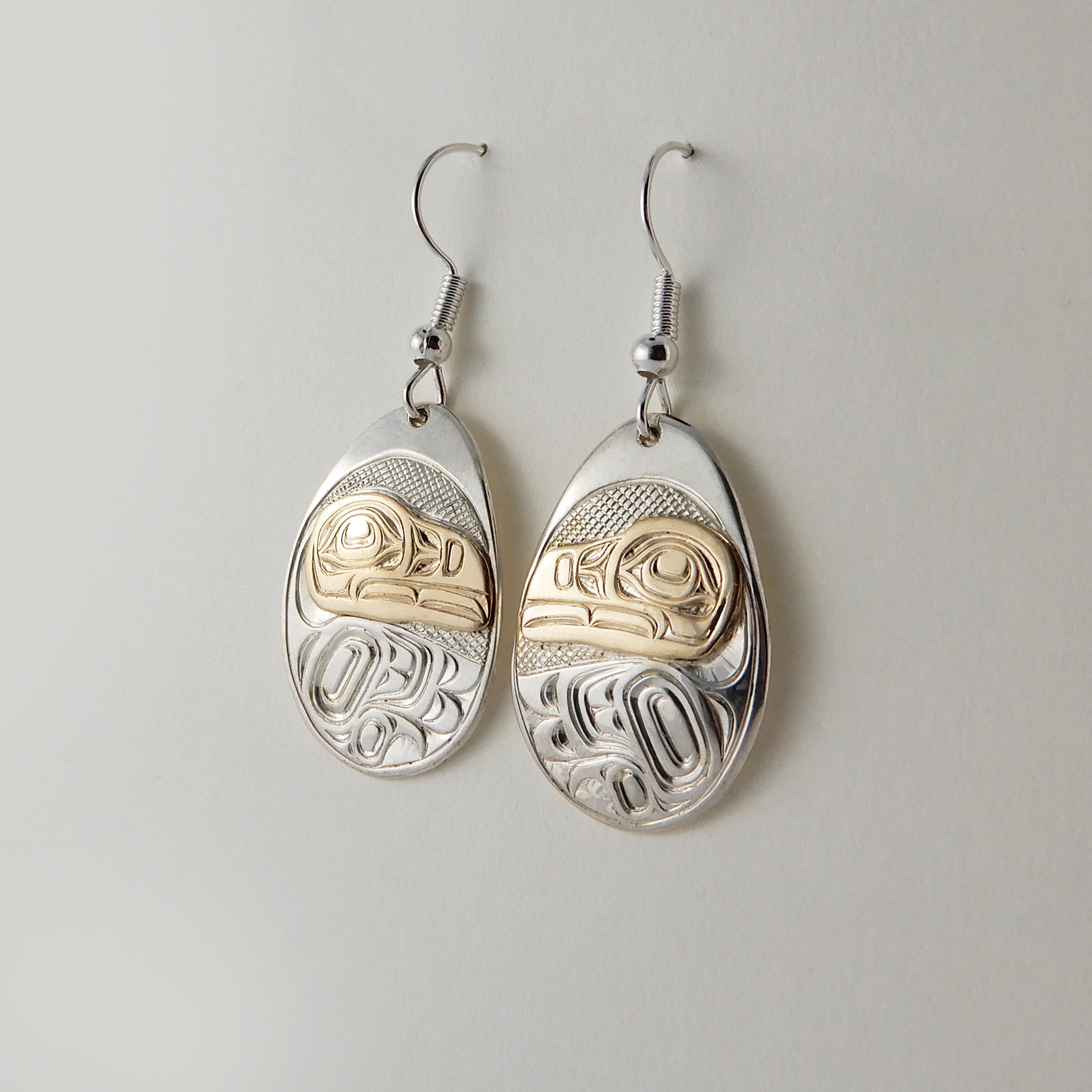 First Nations Silver and Gold Raven Earrings by Kwakwaka'wakw artist Joe Wilson