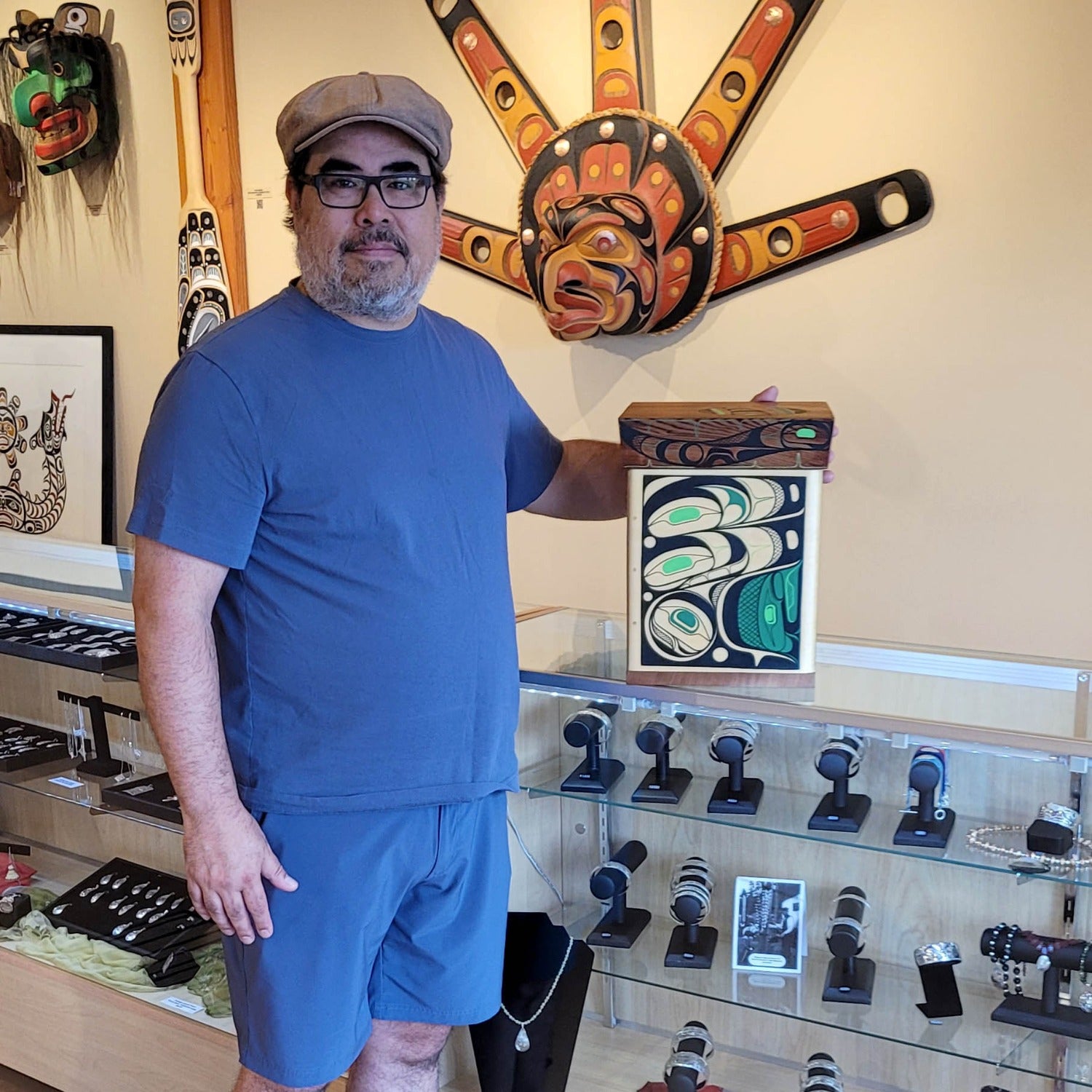 Kwakwaka'wakw artist Rod Smith holding Painted Bentwood Box