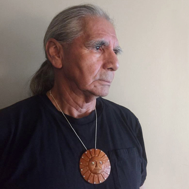Haida Master Carver Ron Russ wearing Yew Sun Pendant