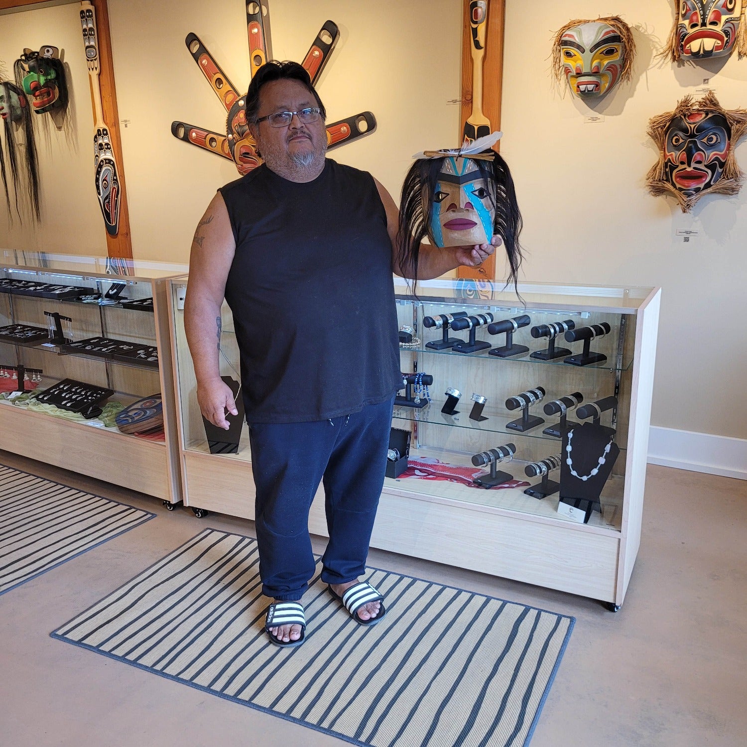 Nuu-chah-nulth carver Russell Tate holding Man in Canoe Mask