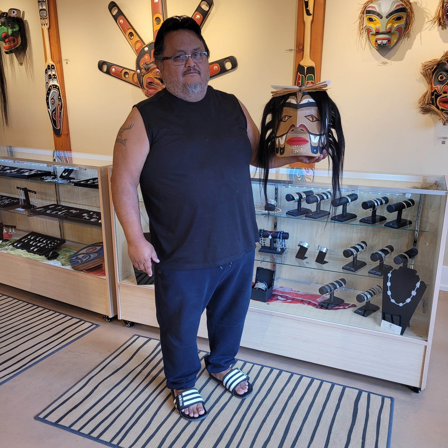 Nuu-chah-nulth carver Russell Tate holding Man in Canoe Mask