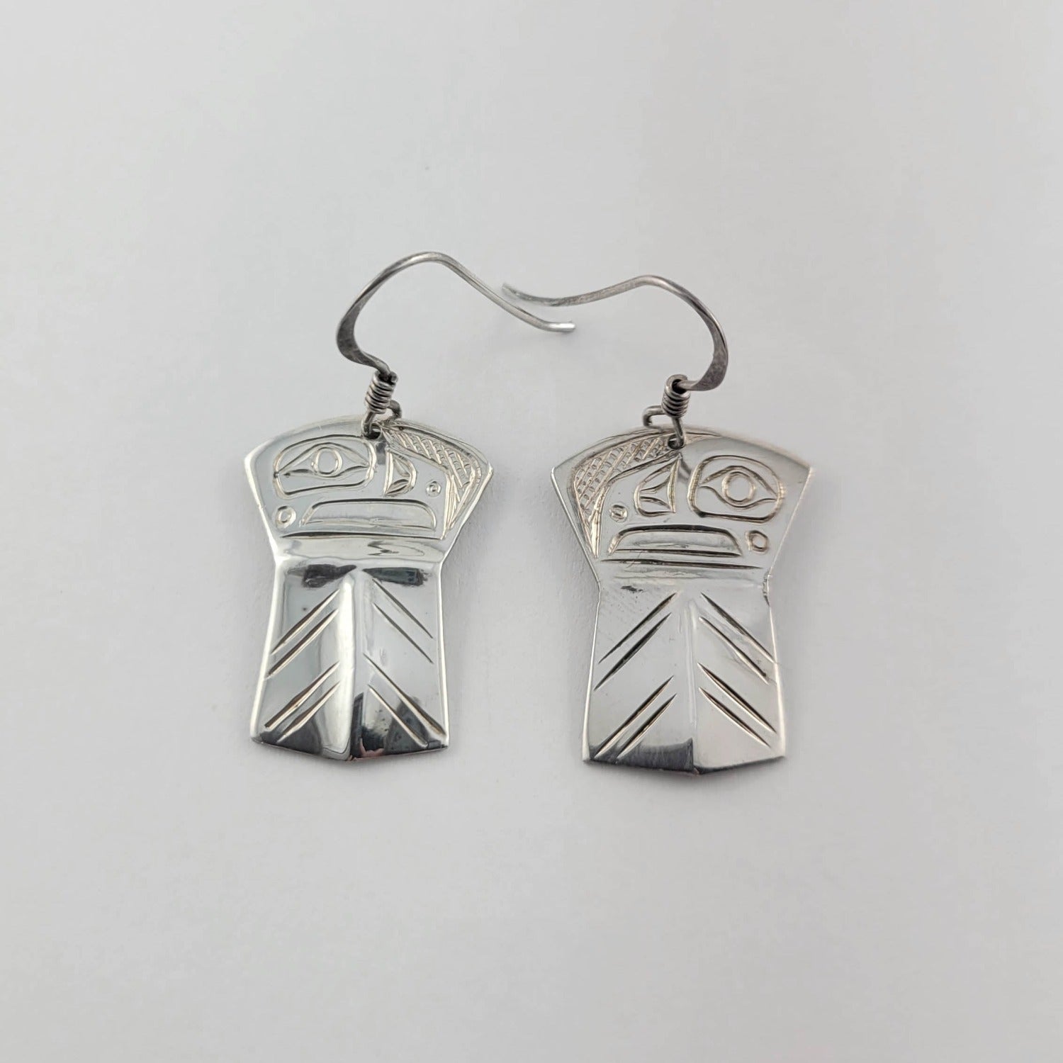 Silver copper-shaped Eagle Earrings by Kwakwaka'wakw artist Chris Cook