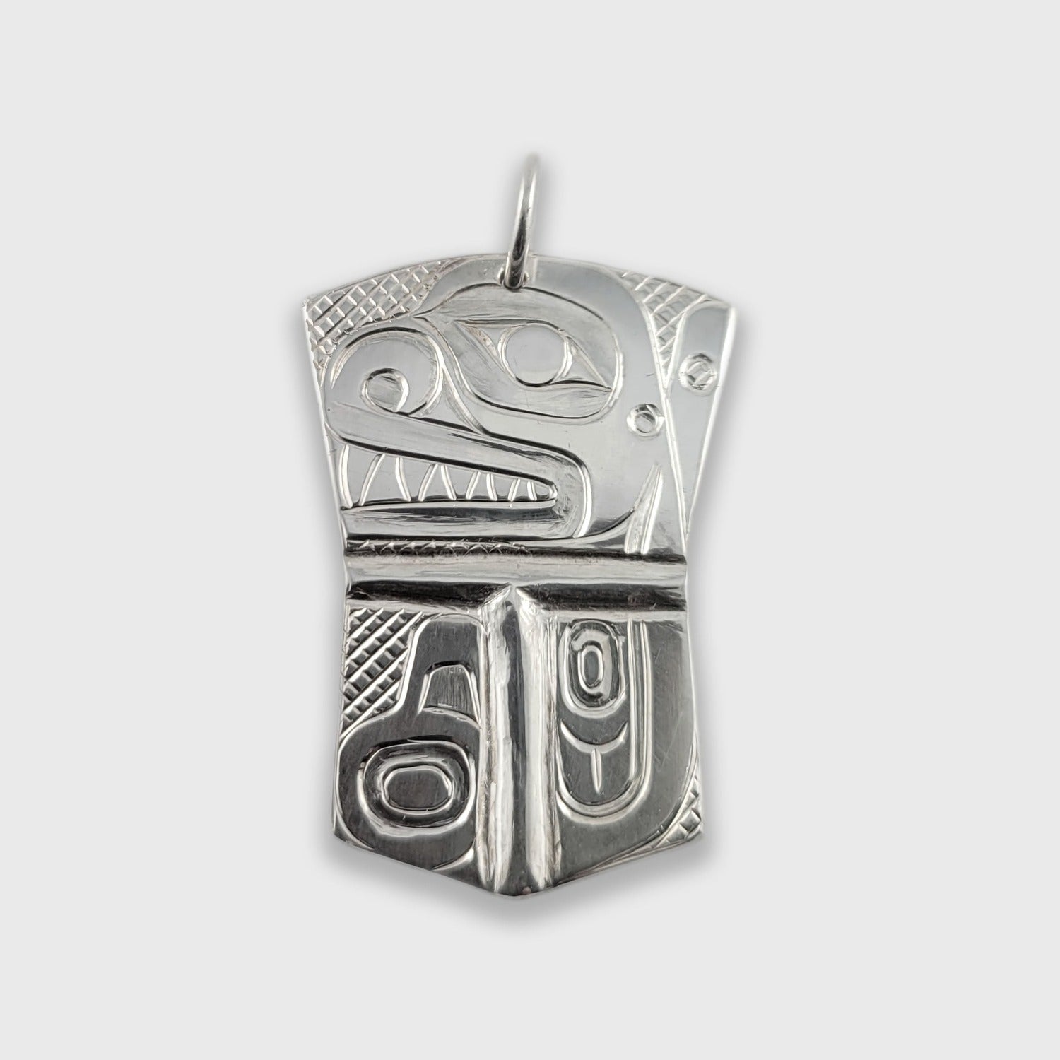 Silver copper-shaped Orca Pendant by Haida artist Derek White