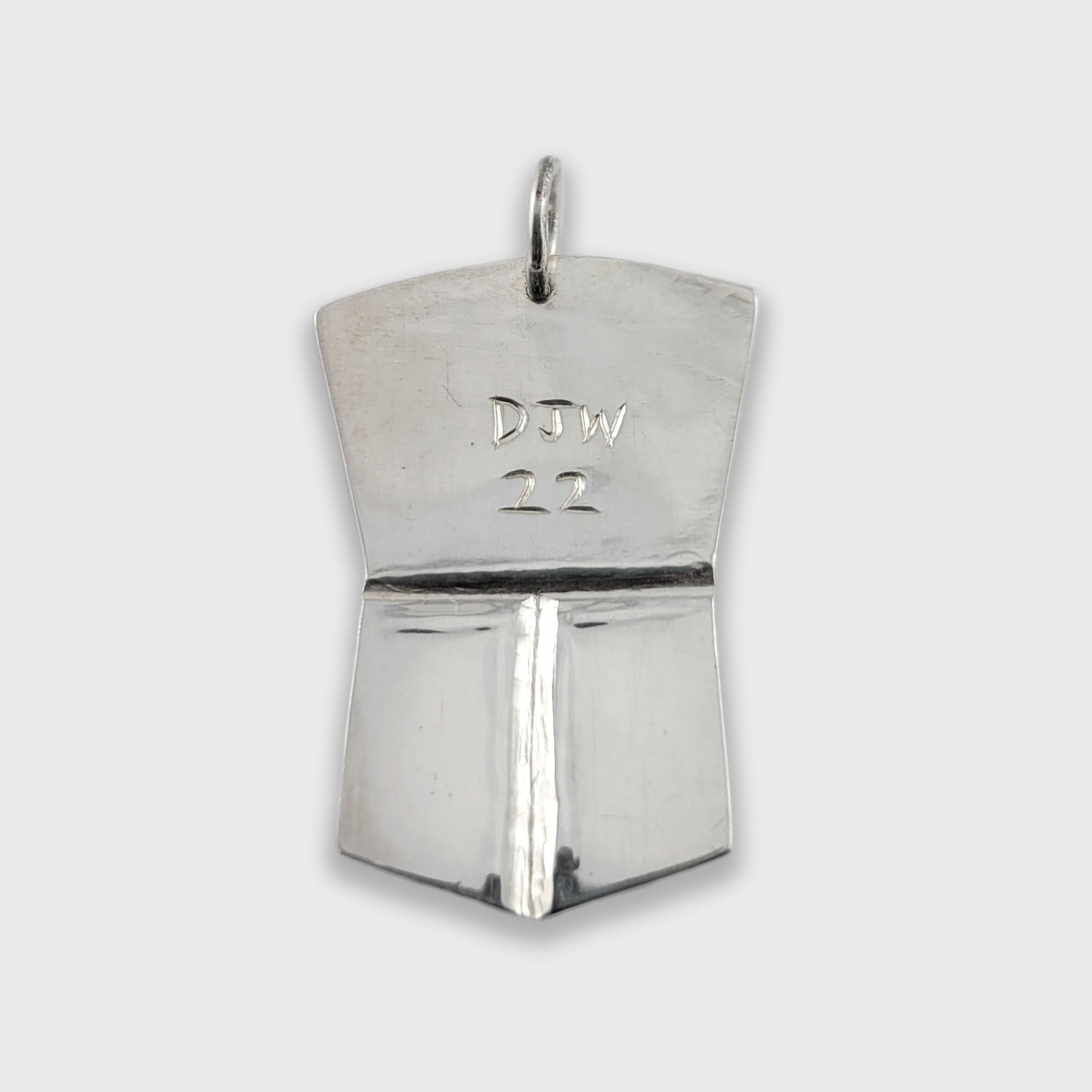 Silver copper-shaped Orca Pendant by Haida artist Derek White