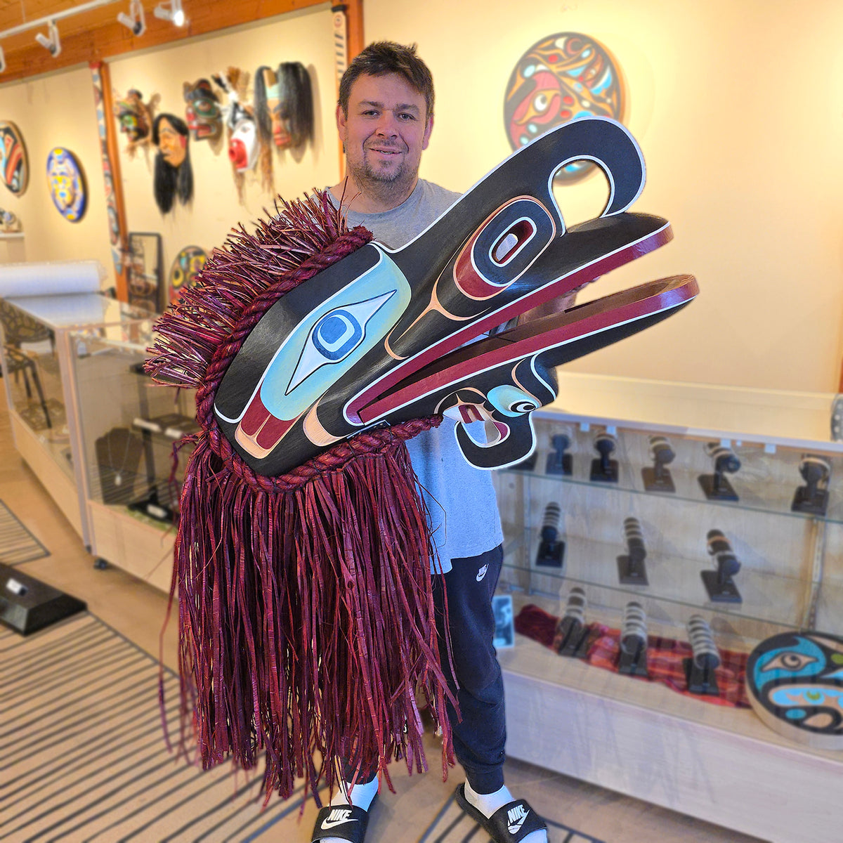Kwakwaka'wakw artist Raymond Shaw holding his Crooked Beak Headdress