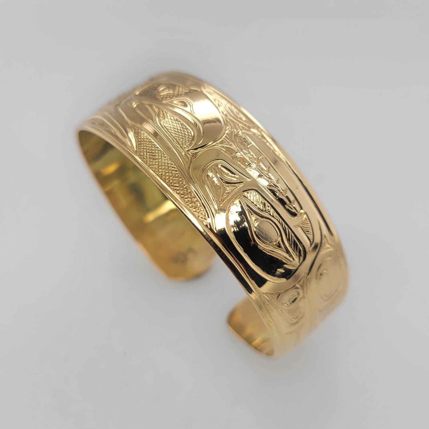 Gold Hummingbird, Eagle, and Orca Bracelet by Tsimshian artist Bill Helin