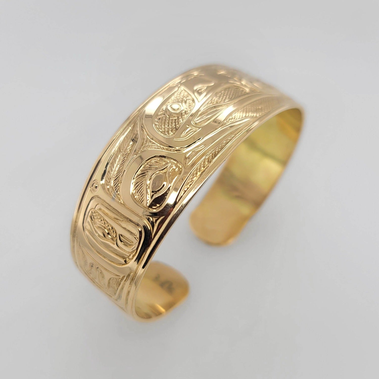 Gold Hummingbird, Eagle, and Orca Bracelet by Tsimshian artist Bill Helin