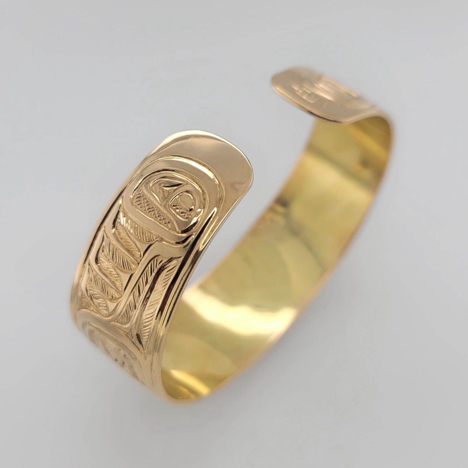 Gold Hummingbird, Eagle, and Orca Bracelet by Tsimshian artist Bill Helin