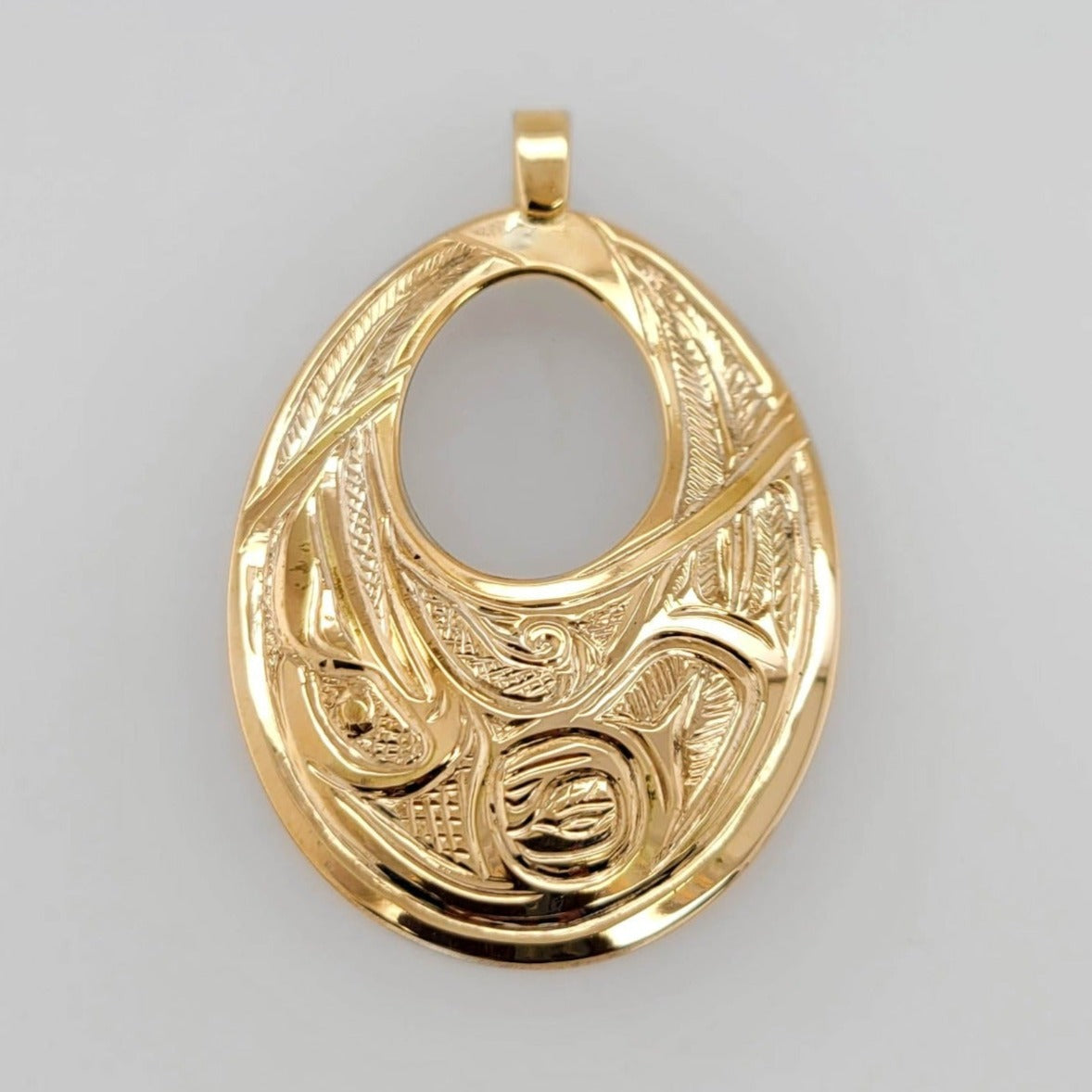 Gold Raven Pendant by Tsimshian artist Bill Helin