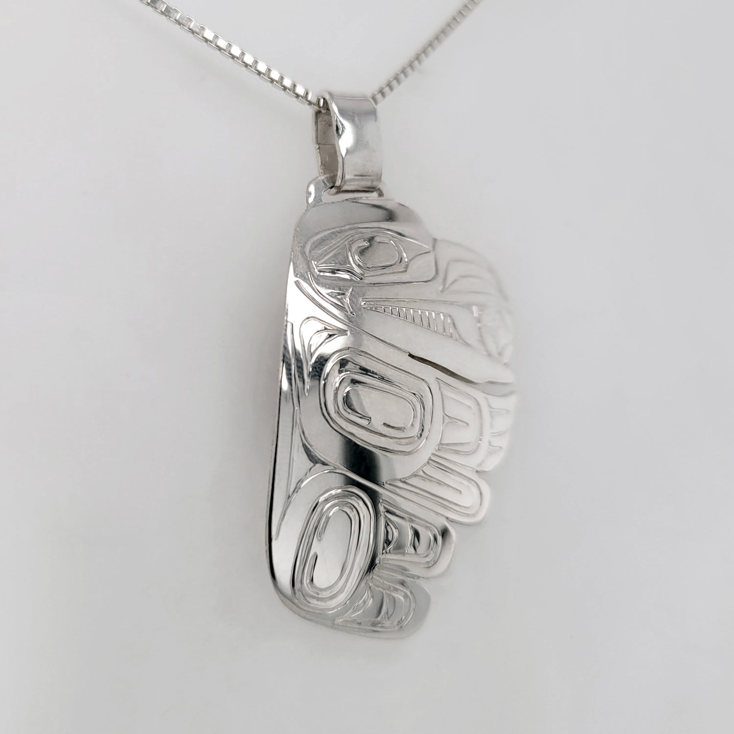 Silver Raven Steals the Light Pendant by Haida artist Garner Moody