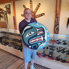 Kwakiutl carver Trevor Hunt holding Native Cedar Bear Panel