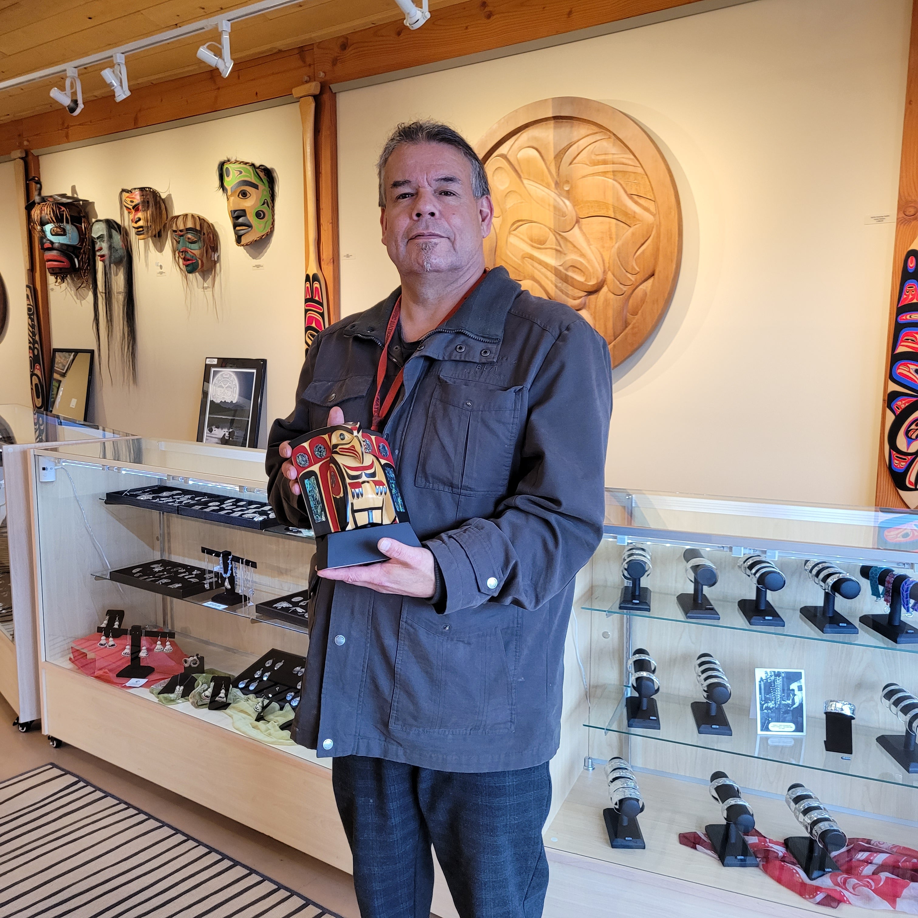 Kwakwaka'wakw carver Greg Henderson holding Eagle Frontlet Mask