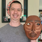 Kwakwaka'wakw artist Erich Glendale holding Red Cedar Portrait Mask