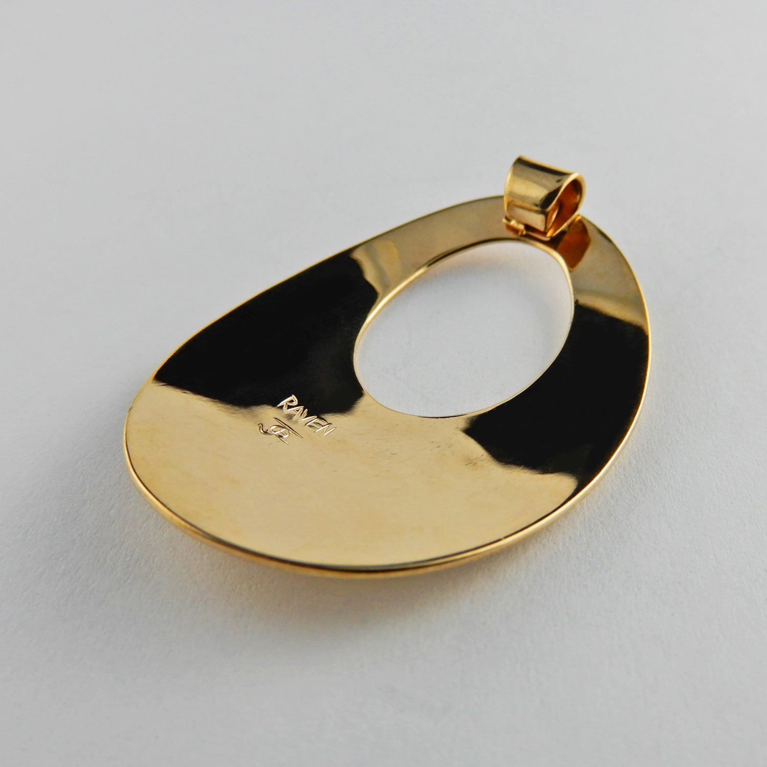 Gold Oval Raven Pendant by Kwakwaka'wakw artist Joe Wilson