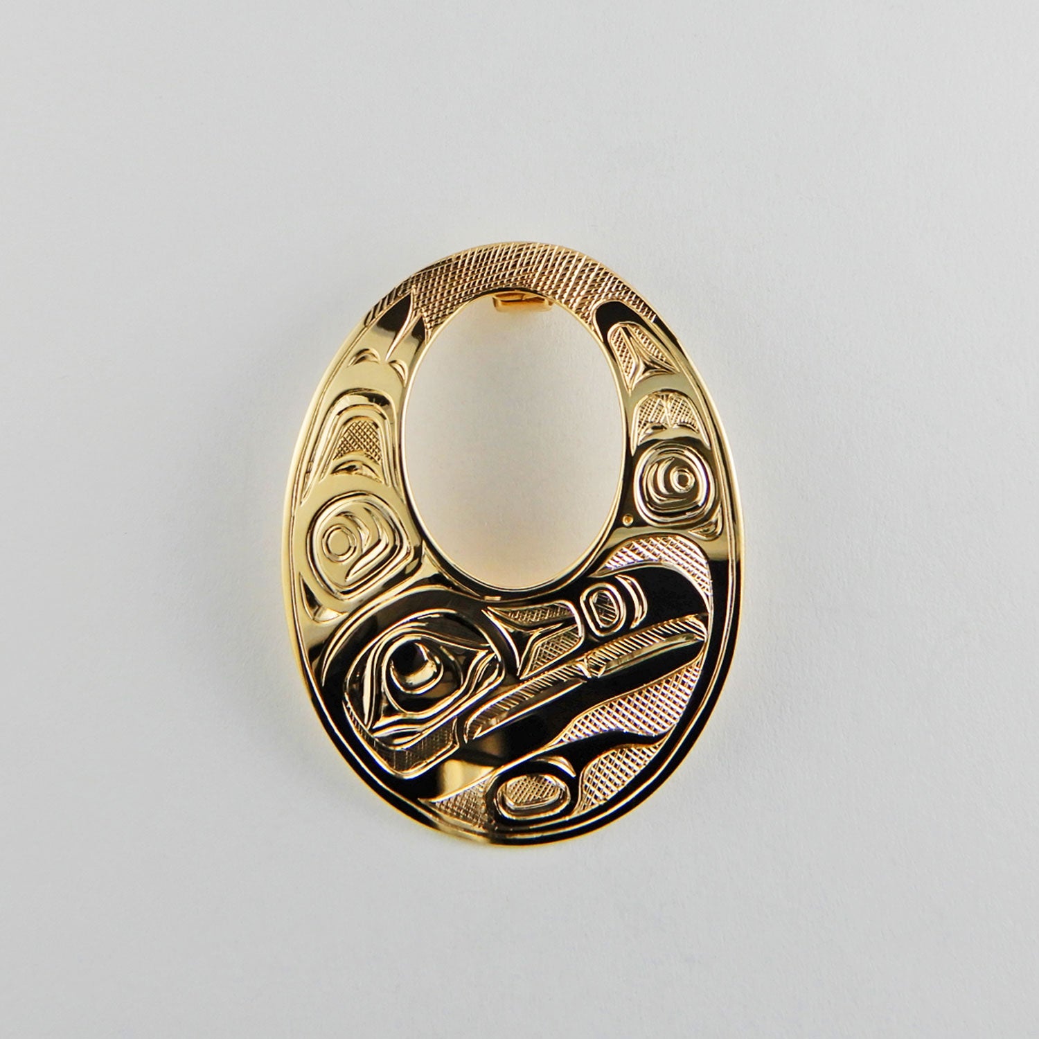 Gold Oval Raven Pendant by Kwakwaka'wakw artist Joe Wilson