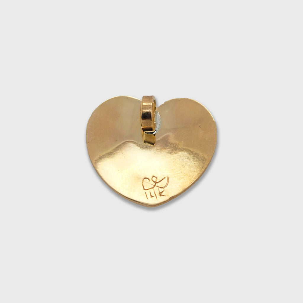 Gold Heart-shaped Eagle pendant by Haida artist Carmen Goertzen