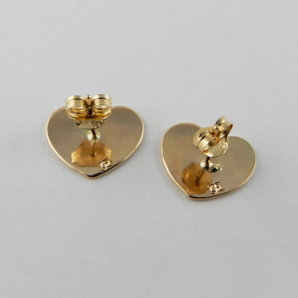 Gold Heart-shaped Raven stud earrings by Kwakwaka'wakw artist Joe Wilson