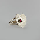 Silver and Garnet Heart-shaped Hummingbird Ring by Kwakwaka'wakw artist Chris Cook