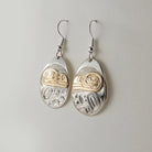 First Nations Silver and Gold Raven Earrings by Kwakwaka'wakw artist Joe Wilson