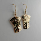 Gold Copper-shaped Raven stud earrings by Kwakwaka'wakw artist Joe Wilson