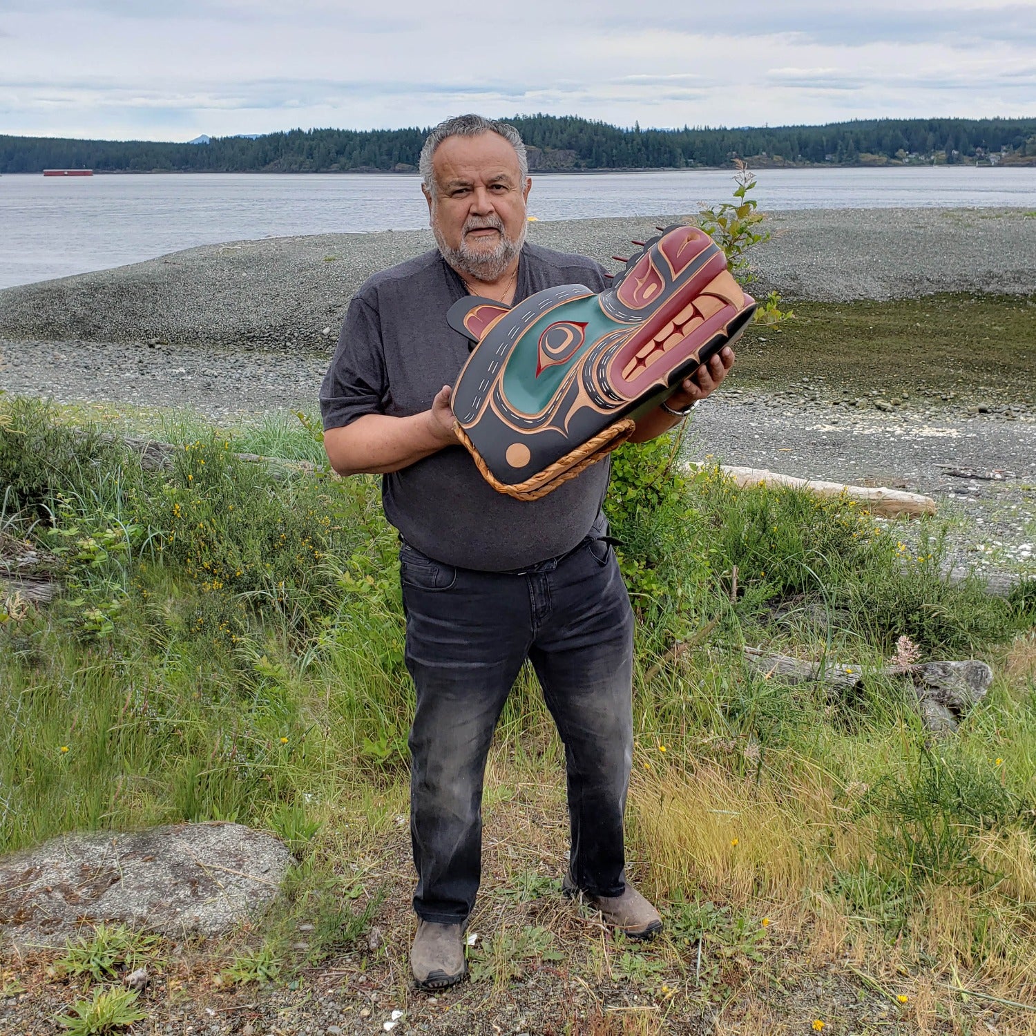 Kwakwaka'wakw Master Carver Bill Henderson holding Sea Bear Mask