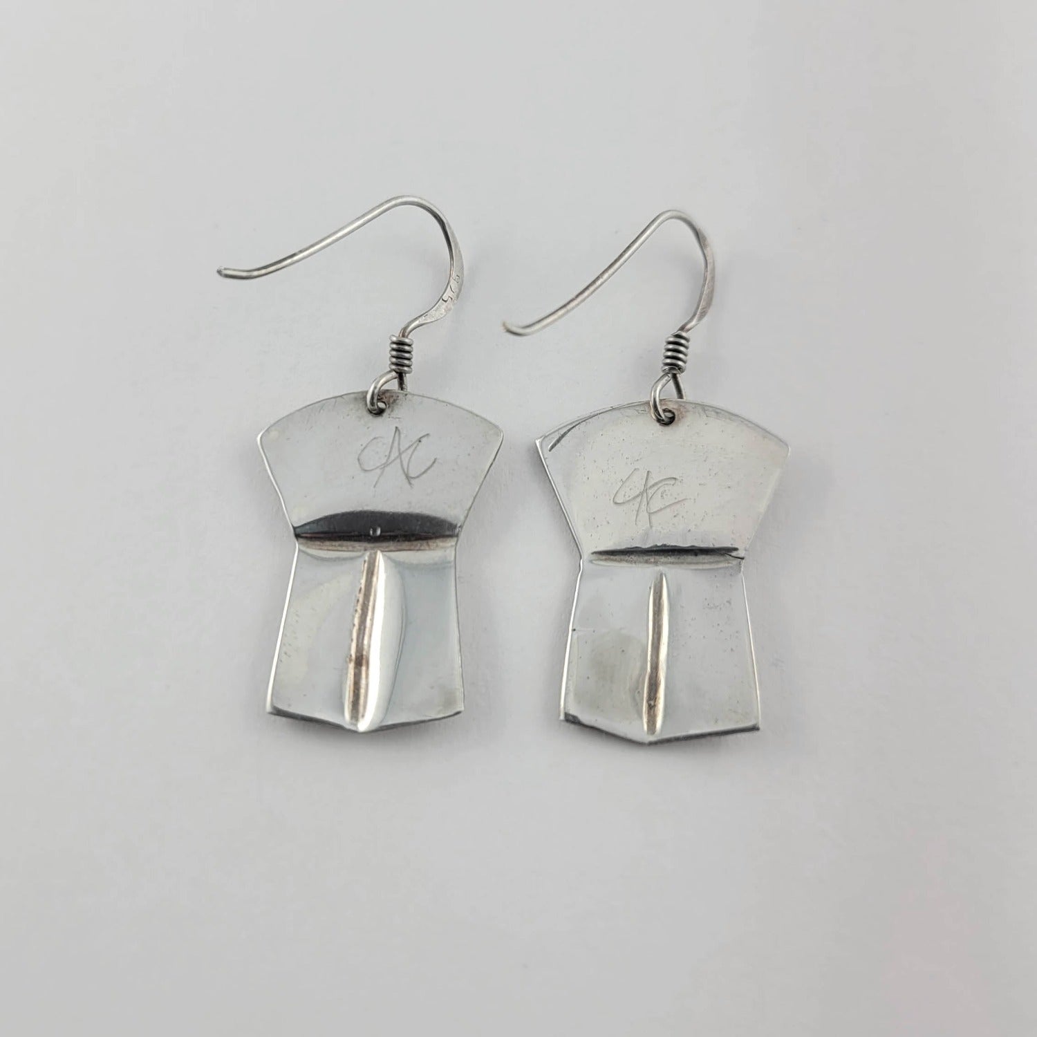 Silver copper-shaped Eagle Earrings by Kwakwaka'wakw artist Chris Cook