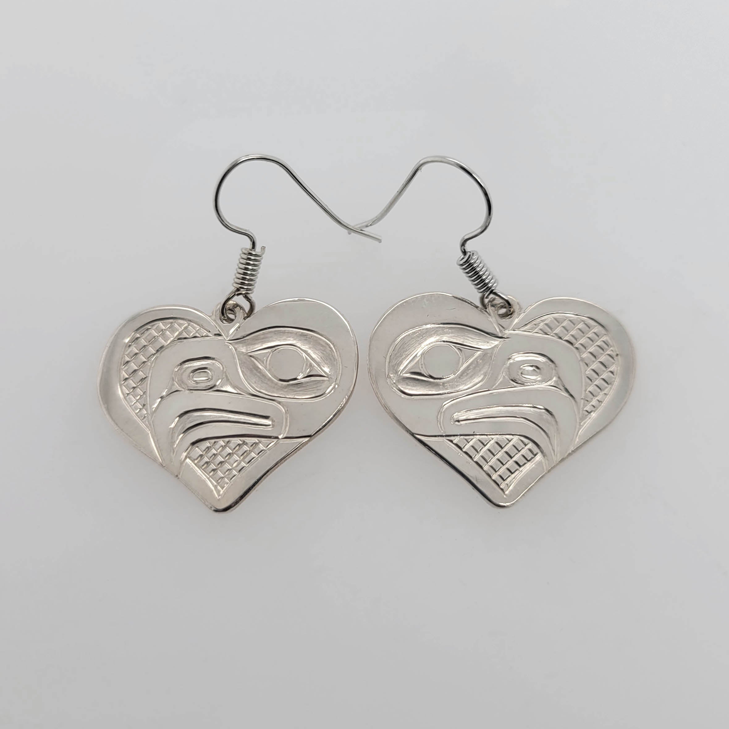 Silver Heart-shaped Eagle Earrings by Kwakwaka'wakw artist Chris Cook