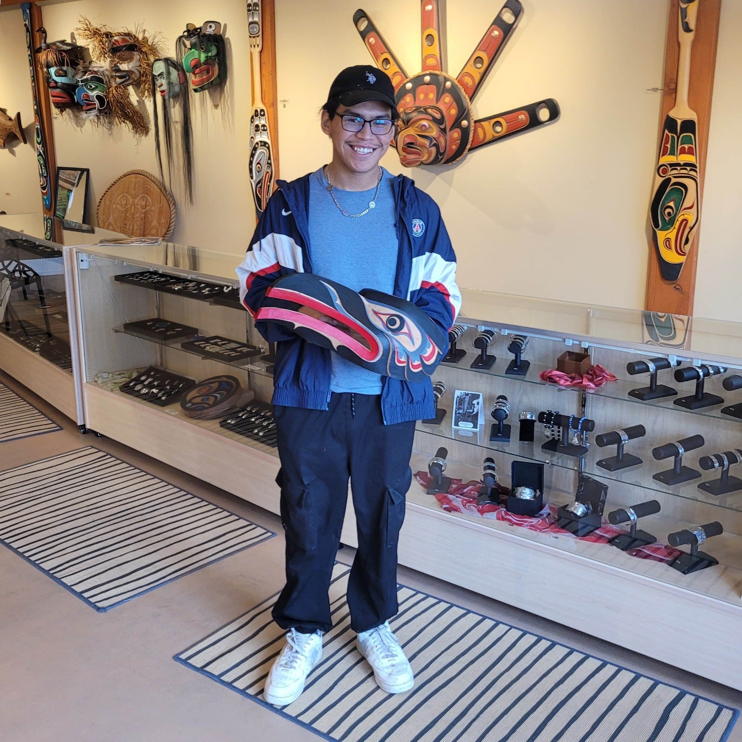 Kwakwaka'wakw carver Talon George holding Raven Mask