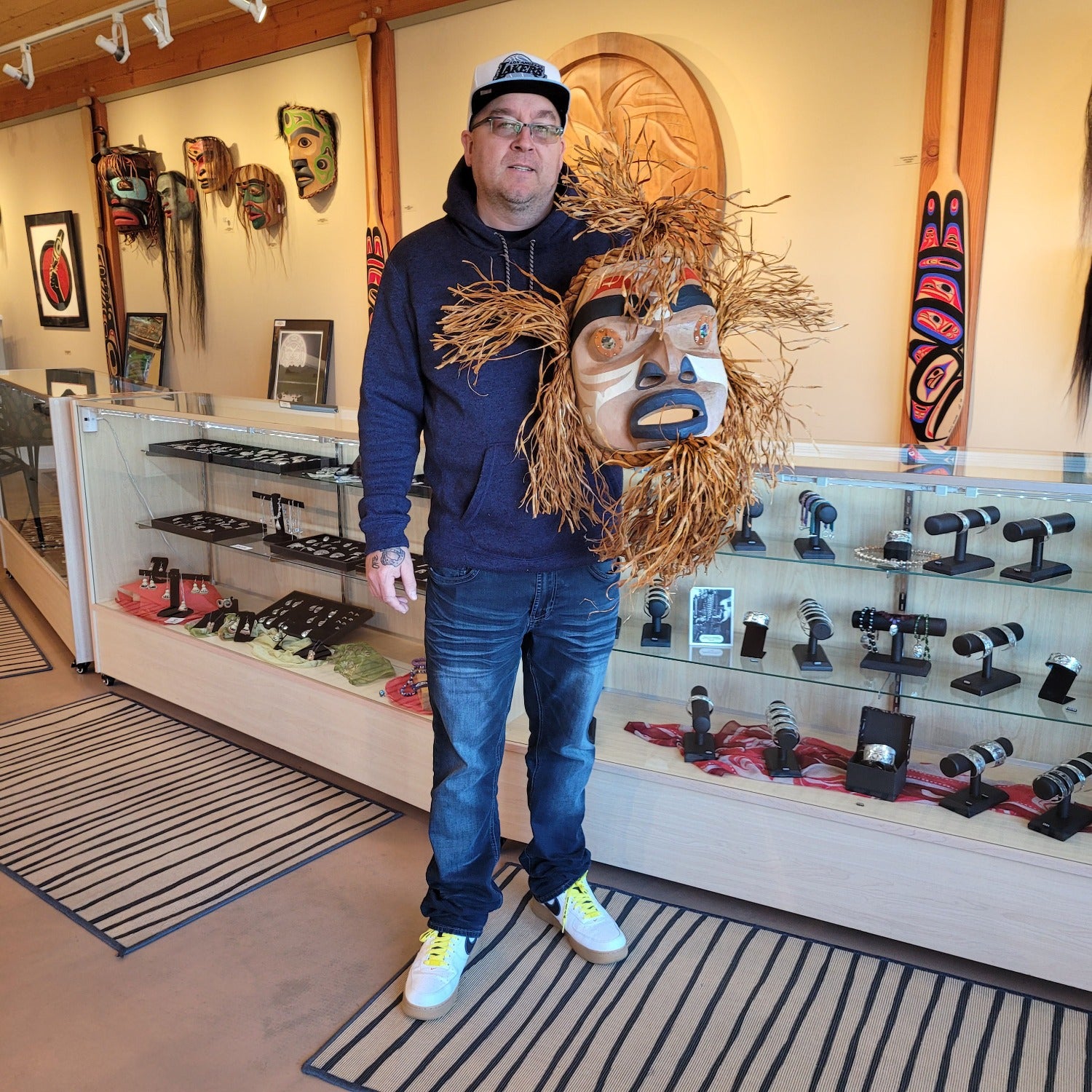 Kwakiutl carver Trevor Hunt holding Cedar Bark Harvest Man Mask