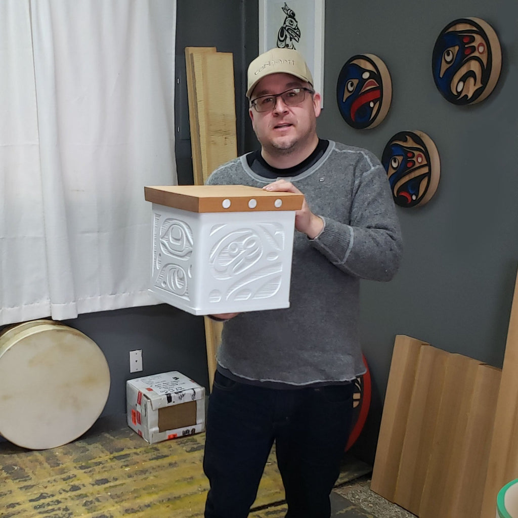 Kwakiutl artist Trevor Hunt holding White Sandblasted Bentwood Box