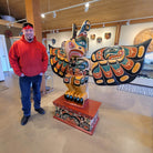 Kwakwaka'wakw carver Junior Henderson with Thunderbird Orca and Sea Serpent Totem Pole